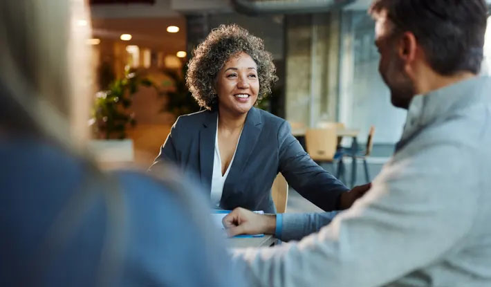 smiling adult woman talking with a man