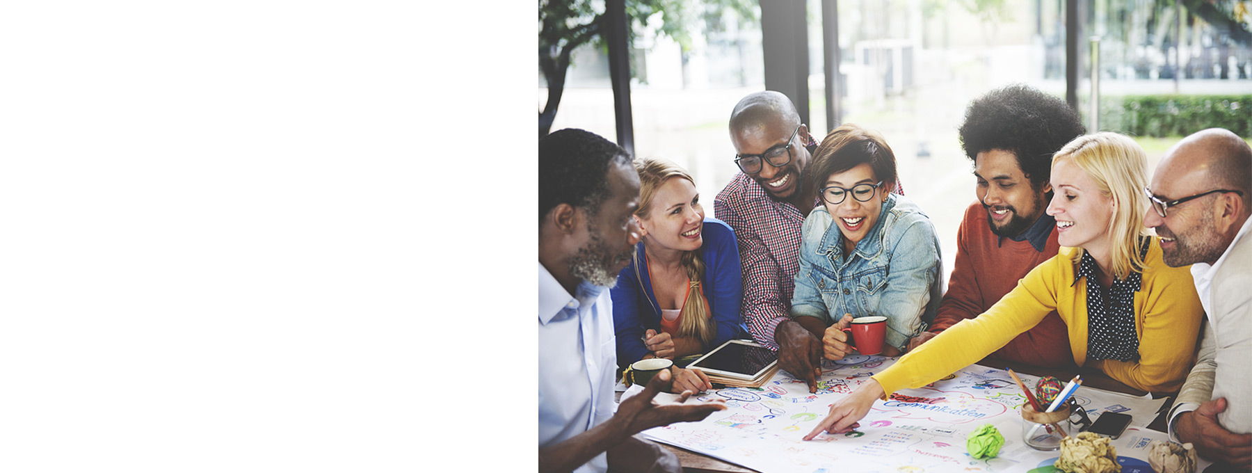 multi-cultural group gathered around a poster